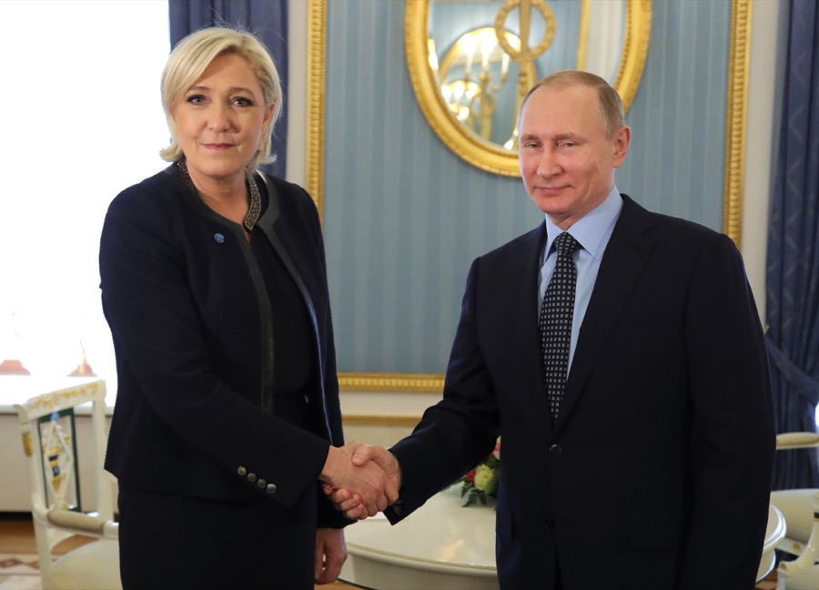 President Vladimir Putin shakes hands with Marine Le Pen President Vladimir Putin shakes hands with Marine Le Pen